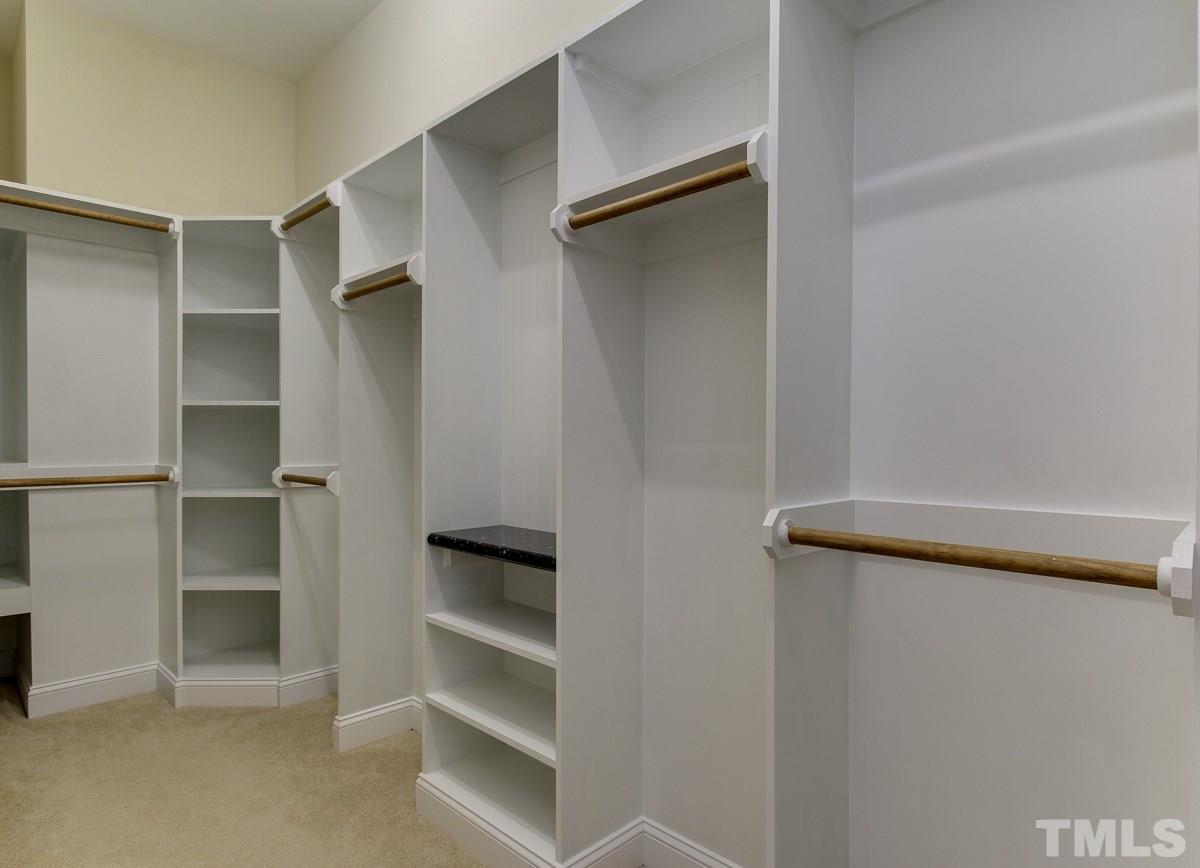 932 Chapanoke Road Raleigh, NC 27603 - Photo 17 of 25 a view of walk in closet with empty racks