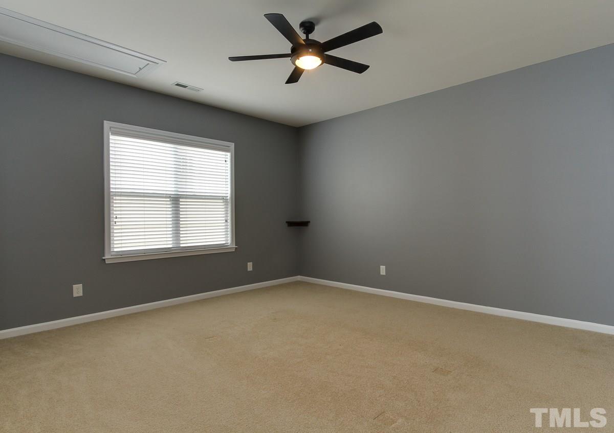 932 Chapanoke Road Raleigh, NC 27603 - Photo 19 of 25 an empty room with a window and a fan