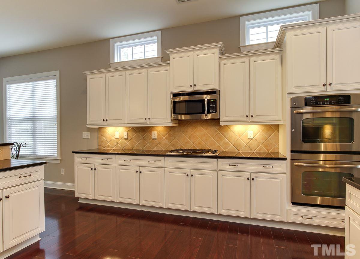 932 Chapanoke Road Raleigh, NC 27603 - Photo 3 of 25 a kitchen with granite countertop white cabinets and appliances
