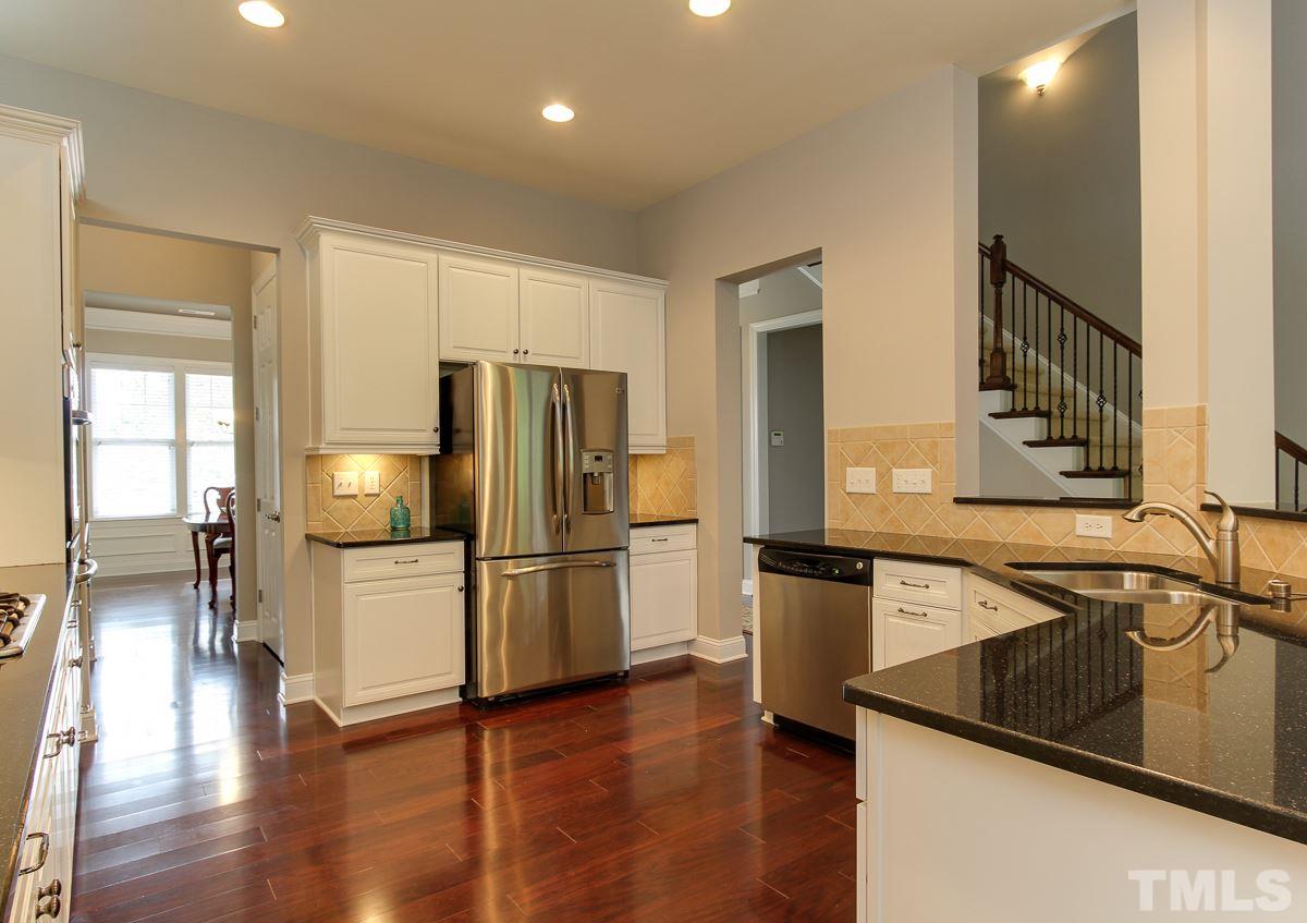 932 Chapanoke Road Raleigh, NC 27603 - Photo 4 of 25 a kitchen with a refrigerator and a sink