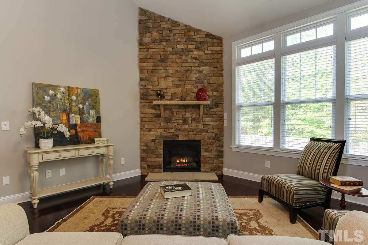 932 Chapanoke Road Raleigh, NC 27603 - Photo 8 of 25 a living room with furniture and a fireplace
