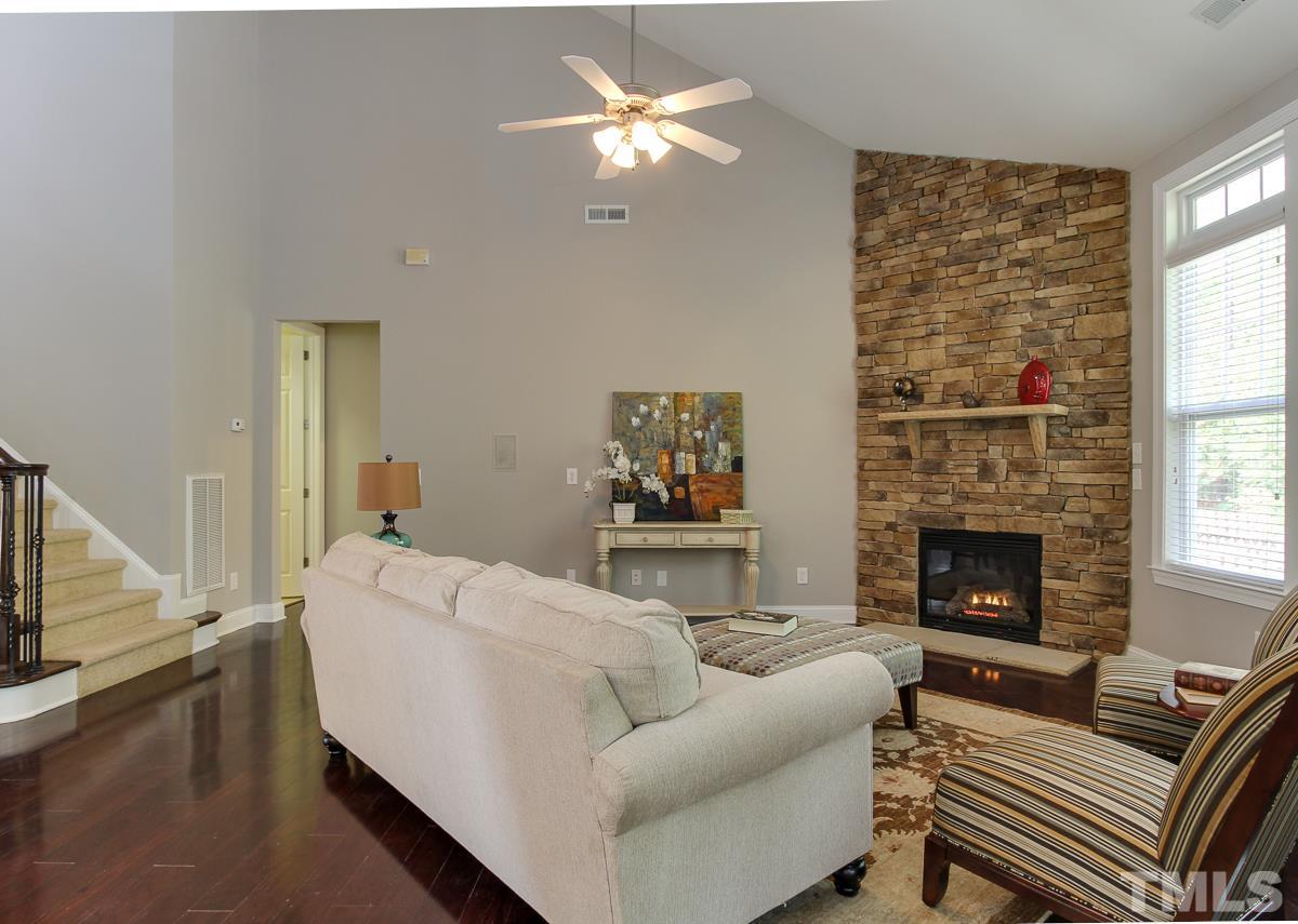 932 Chapanoke Road Raleigh, NC 27603 - Photo 10 of 25 a living room with furniture and a fireplace