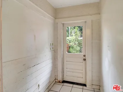 a view of an entryway with wooden floor and windows