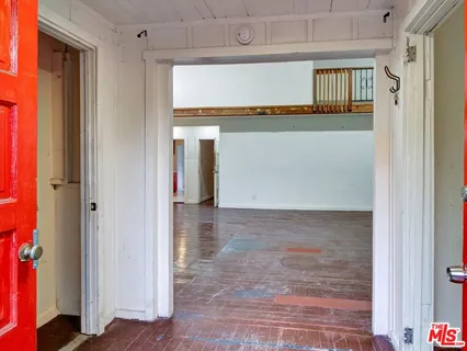 a view of a hallway with wooden floor and entryway