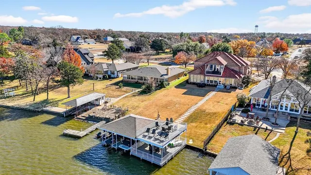 an aerial view of a house with swimming pool and outdoor seating
