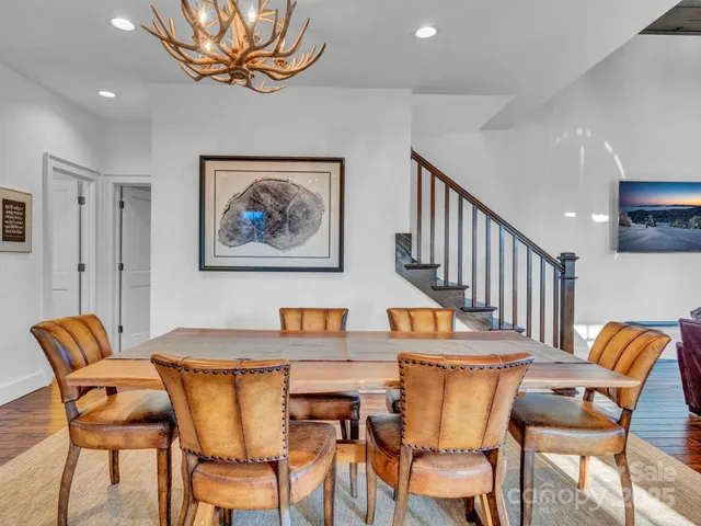 a dining room with furniture and wooden floor