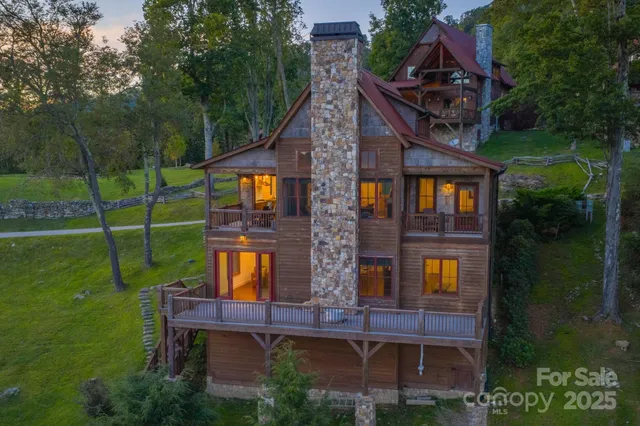 an aerial view of a house with swimming pool garden and balcony