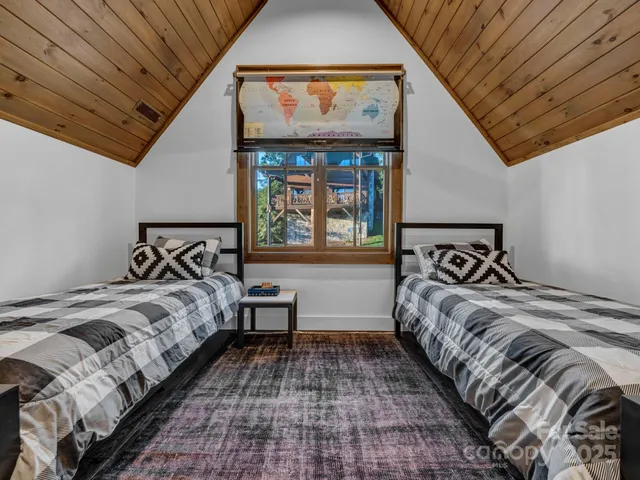 a bed sitting in a bedroom next to a window