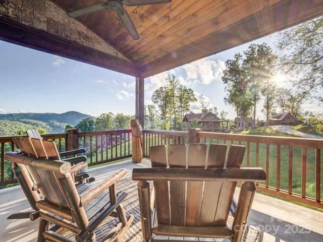 a view of a balcony with wooden floor and outdoor seating