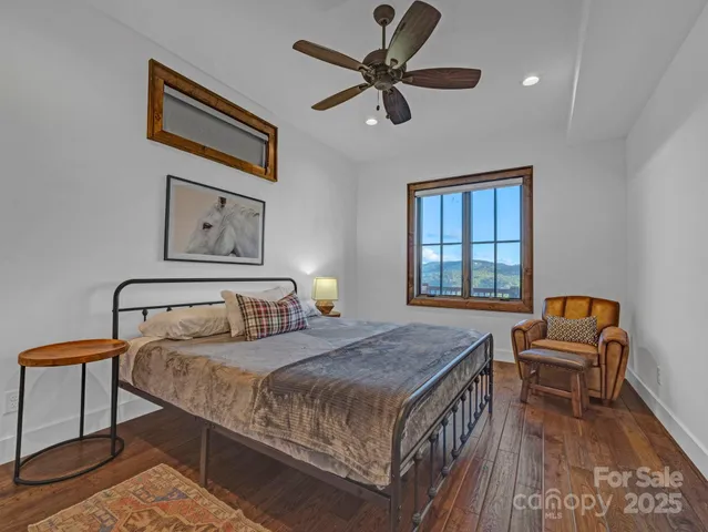 a bedroom with a bed and a dresser next to a window