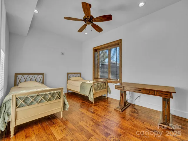 a bedroom with a bed a dresser and a window