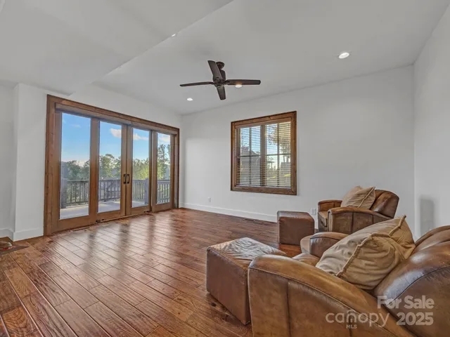 a living room with furniture and two windows