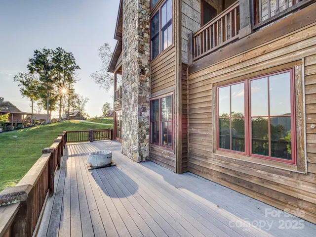 a view of a roof deck with couches and wooden floor