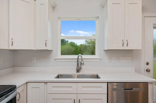 a kitchen with a sink and cabinets