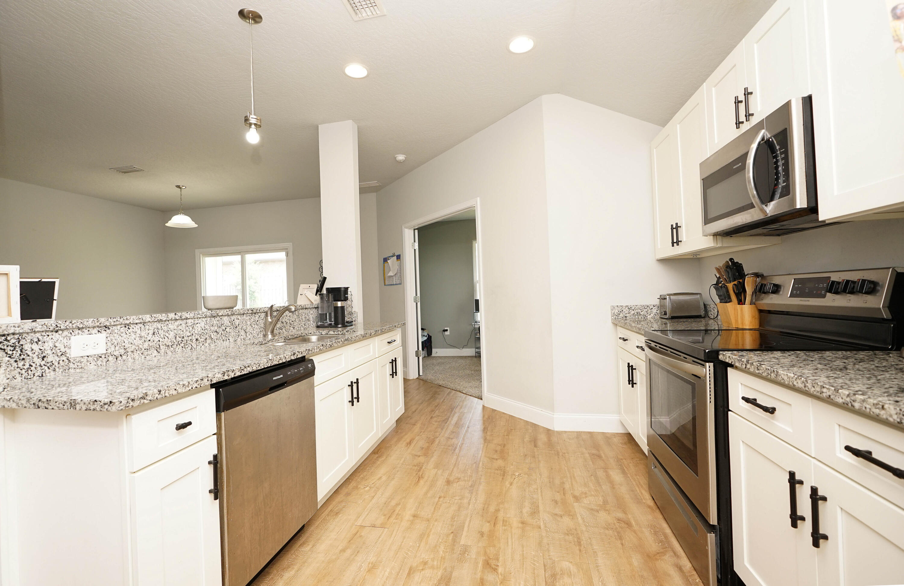 415 Scooter Cove Crestview, FL 32539 - Photo 20 of 45 a kitchen with stainless steel appliances granite countertop a sink and cabinets