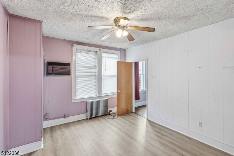 36 Edison Street Bloomfield, NJ 07003 - Photo 10 of 28 an empty room with wooden floor fan and windows