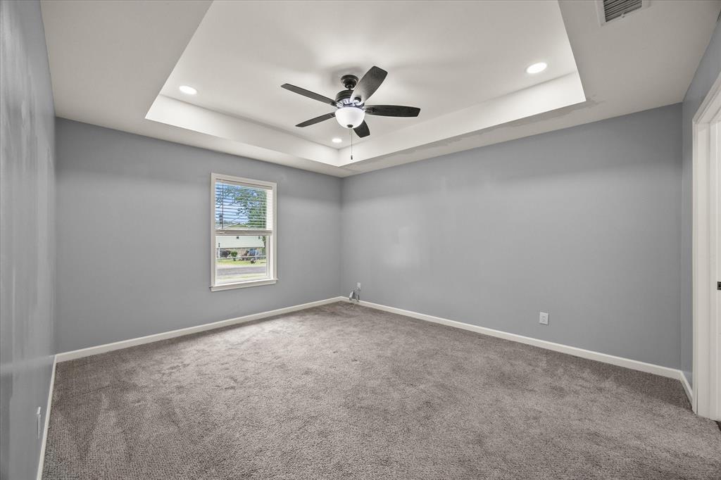 9469 Lakeland Loop Quinlan, TX 75474 - Photo 16 of 31 an empty room with windows and ceiling fan