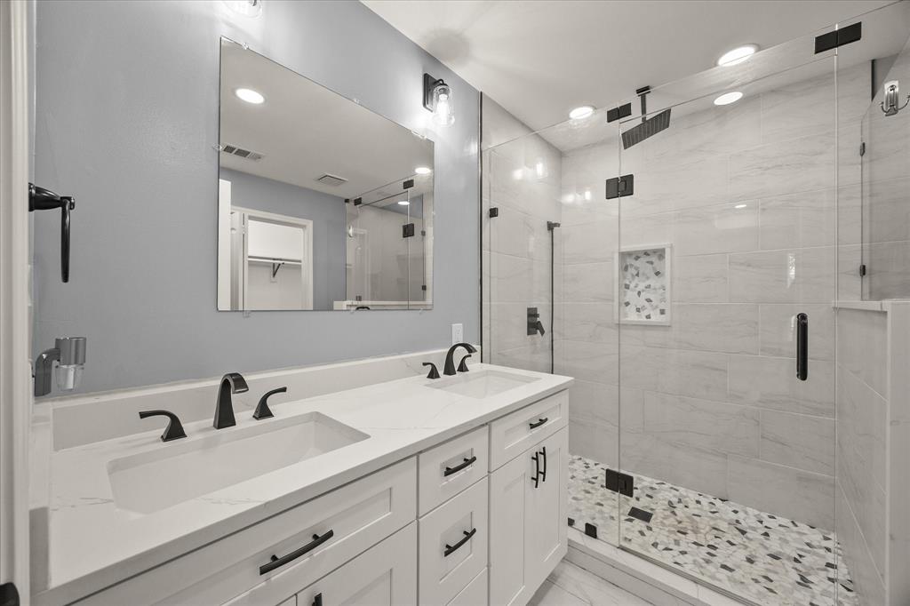 9469 Lakeland Loop Quinlan, TX 75474 - Photo 18 of 31 a bathroom with a sink double vanity and shower