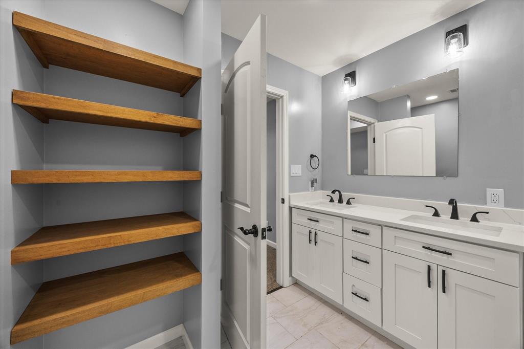 9469 Lakeland Loop Quinlan, TX 75474 - Photo 19 of 31 a bathroom with a sink and a mirror