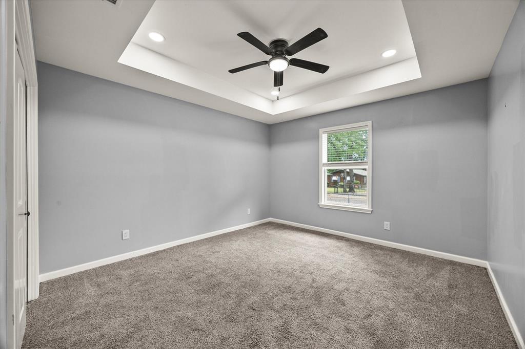 9469 Lakeland Loop Quinlan, TX 75474 - Photo 20 of 31 an empty room with ceiling fan and windows
