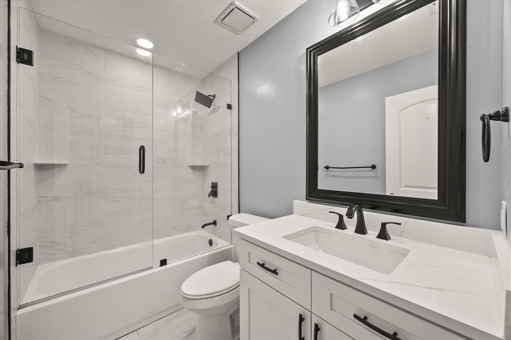 9469 Lakeland Loop Quinlan, TX 75474 - Photo 22 of 31 a bathroom with a sink a toilet and shower
