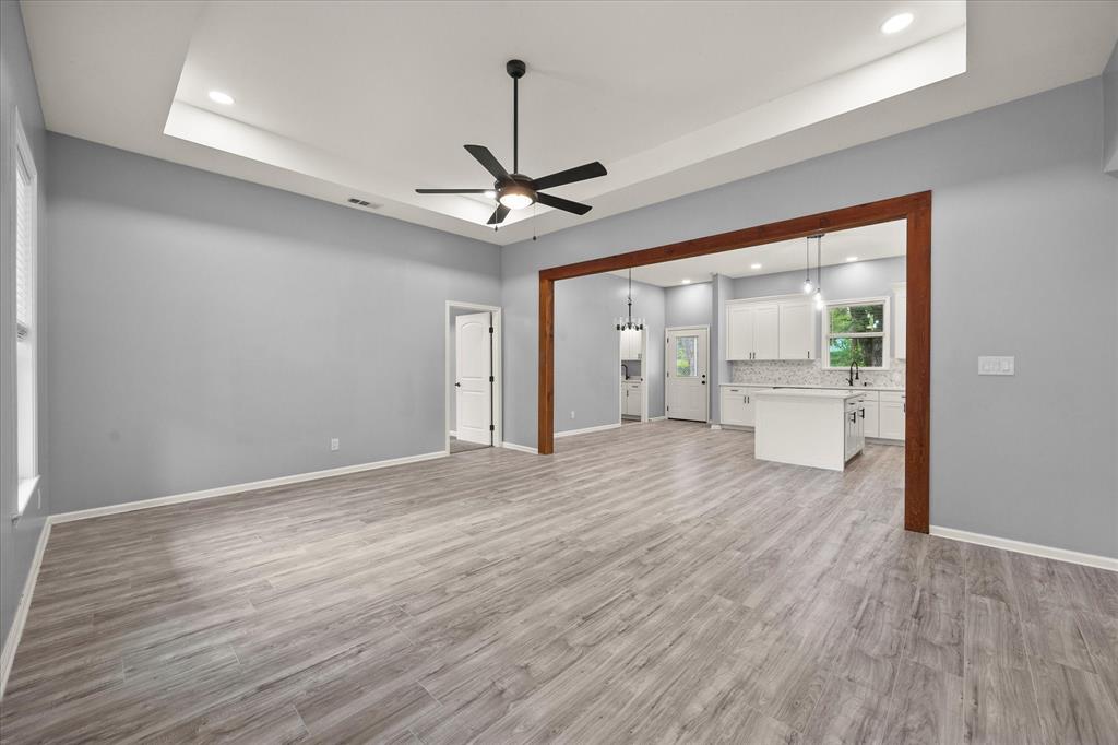 9469 Lakeland Loop Quinlan, TX 75474 - Photo 7 of 31 a view of empty room with wooden floor and ceiling fan