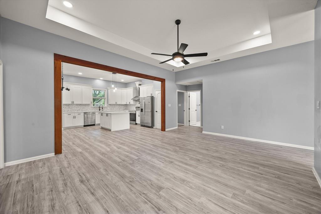 9469 Lakeland Loop Quinlan, TX 75474 - Photo 8 of 31 a view of an empty room with window and wooden floor