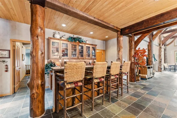 a dining area with a table and chairs