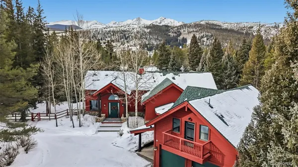 an aerial view of multiple houses with a yard
