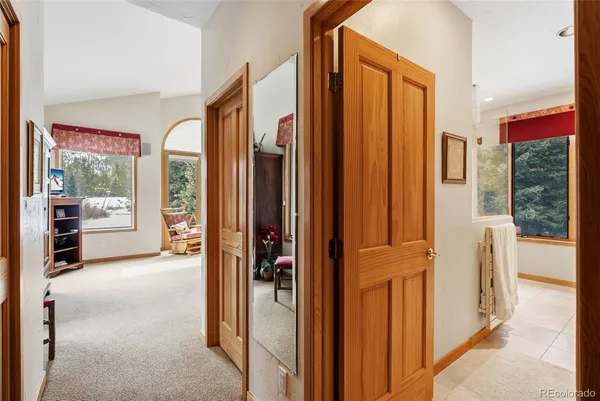 a view of a hallway with furniture and a livingroom view