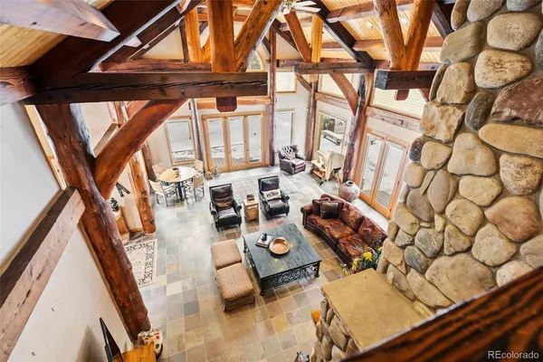 a view of living room with furniture and a floor to ceiling window