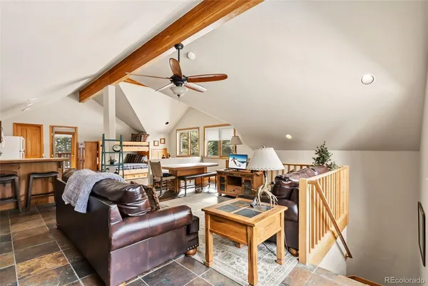 a living room with furniture a fireplace and wooden floor