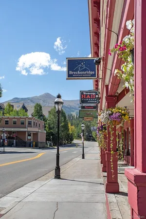 a sign board with buildings in the background