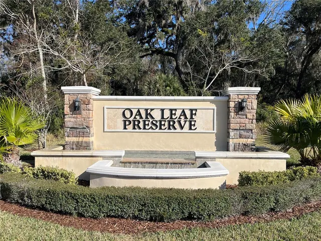 a large white bed sitting in a bedroom next to a window