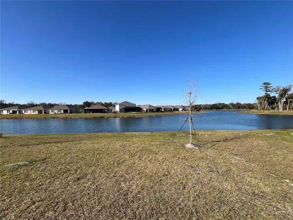a view of a lake with houses in the back