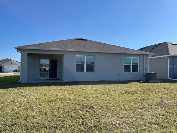 a bed room with a bed and a large window