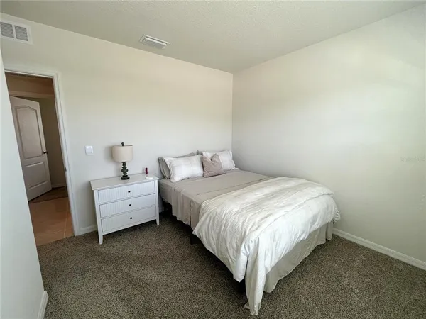 a bedroom with a bed and a mirror