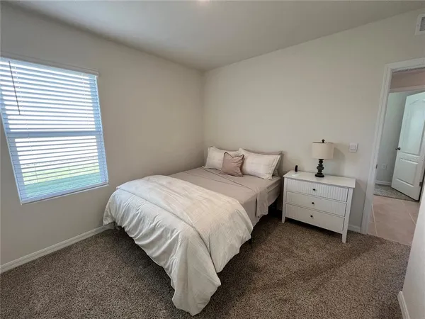 a bed room with a bed and a white wall