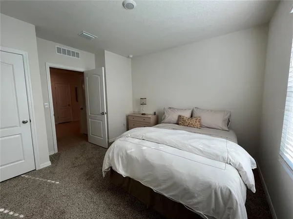 a bed room with a bed and a chair