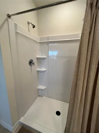 a bathroom with a shower and a toilet