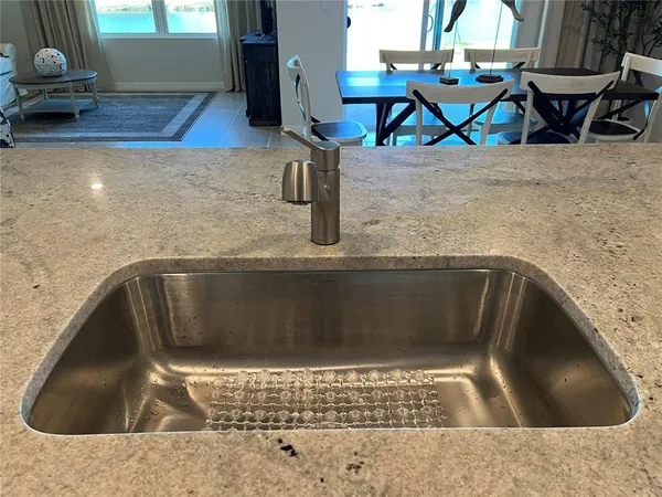 a kitchen with stainless steel appliances granite countertop a stove a refrigerator and a microwave