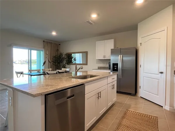 a living room with furniture a large window and a flat screen tv