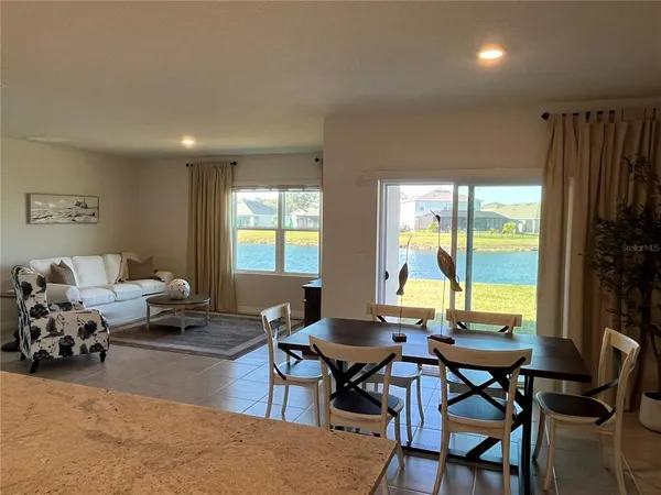 a kitchen with stainless steel appliances granite countertop a stove a sink a microwave and a refrigerator