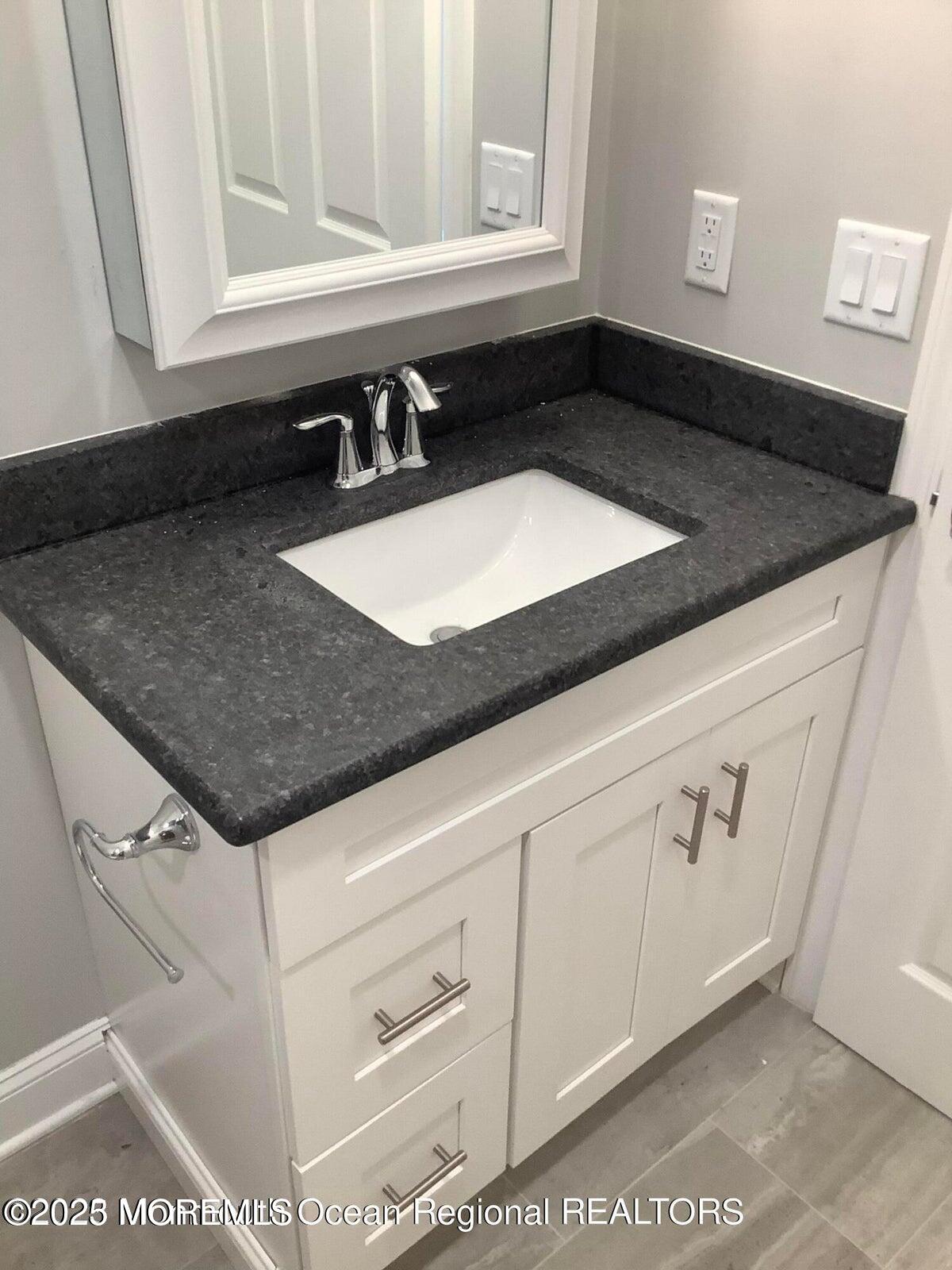 506 Harding Road, Unit 6 Freehold, NJ 07728 - Photo 15 of 21 a kitchen with granite countertop a sink and a stove