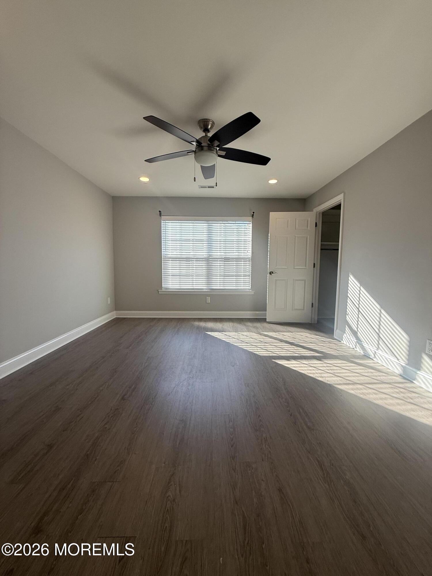 506 Harding Road, Unit 6 Freehold, NJ 07728 - Photo 28 of 31 an empty room with wooden floor and windows
