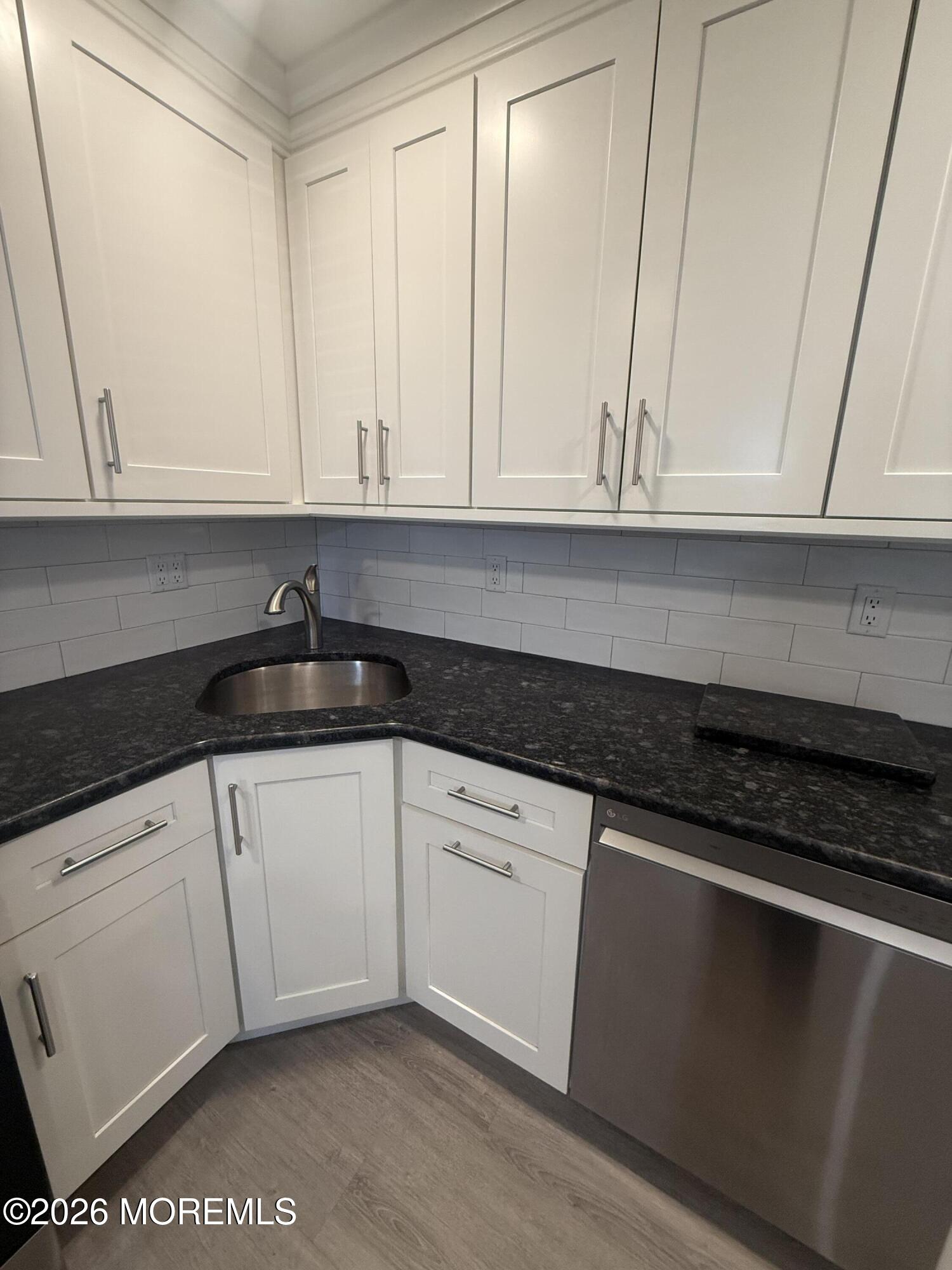 506 Harding Road, Unit 6 Freehold, NJ 07728 - Photo 4 of 31 a kitchen with granite countertop white cabinets and a sink