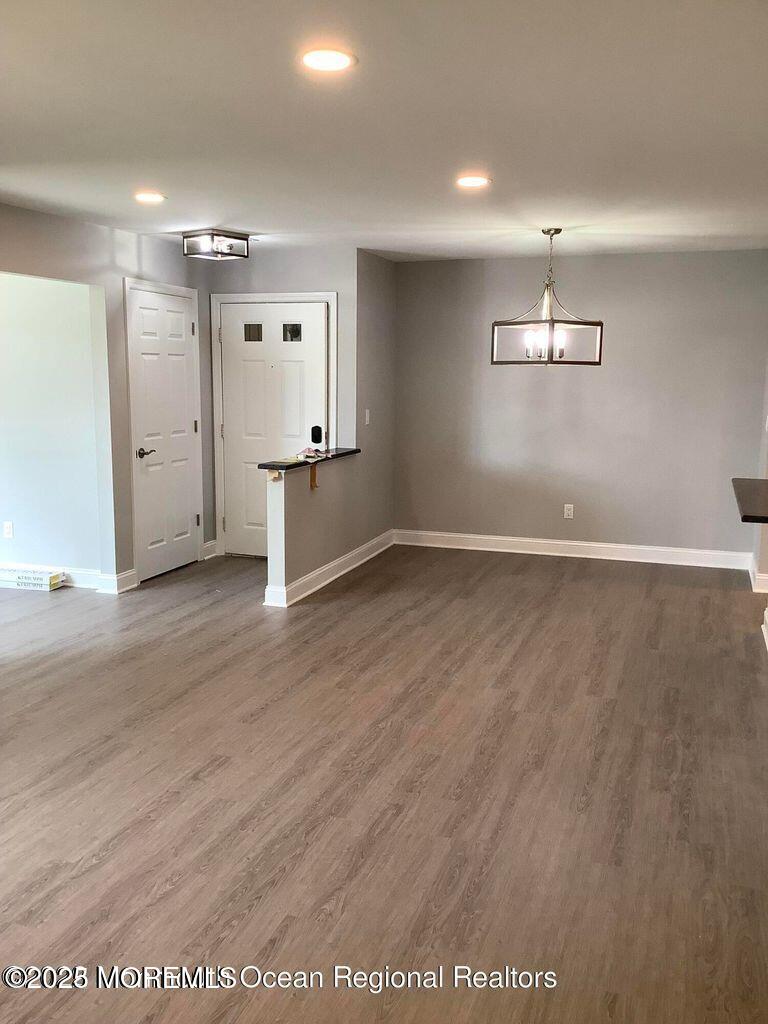 506 Harding Road, Unit 6 Freehold, NJ 07728 - Photo 9 of 21 an empty room with wooden floor and windows