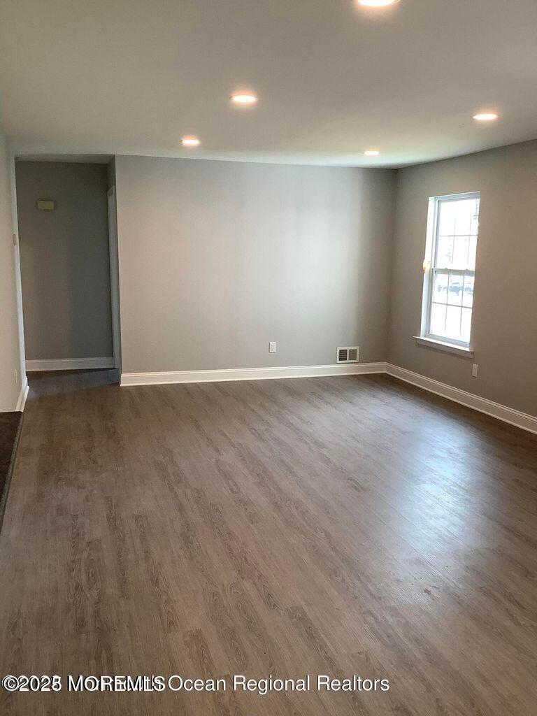 506 Harding Road, Unit 6 Freehold, NJ 07728 - Photo 10 of 21 an empty room with wooden floor and windows