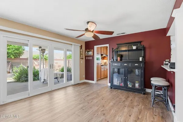 a kitchen with granite countertop a sink window and cabinets
