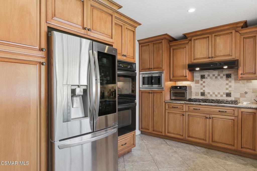 1837 Marcella Street Simi Valley, CA 93065 - Photo 14 of 66 a kitchen with stainless steel appliances granite countertop a refrigerator and cabinets
